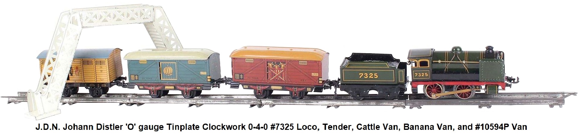 J.D.N. Johann Distler 'O' gauge tinplate lithographed clockwork freight train set with #7325 steam outline locomotive and tender, two distinctive freight wagons, one with bananas, one with three cows, and a third wagon #10594P depicting a Mexican holding bananas